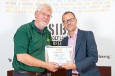Elgood's Head Brewer Alan Pateman receiving the Gold Award for Cherry Wheat from Mike Benner of SIBA.
