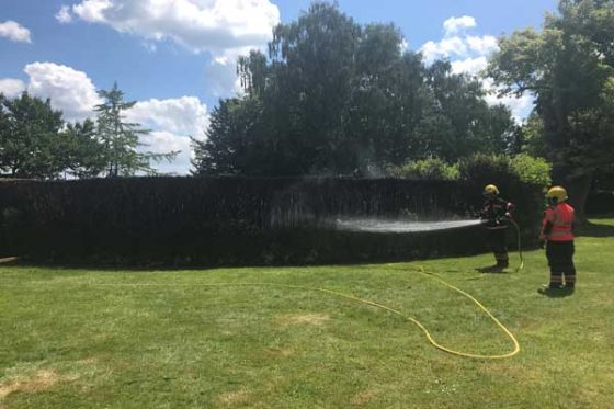 Firefighters damp down the maze